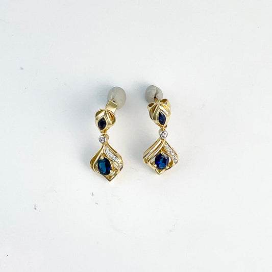 18K gold earrings with blue sapphires.