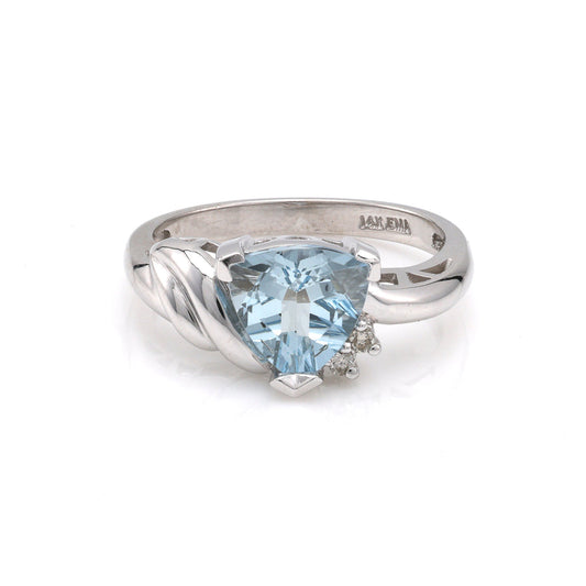Triangular aquamarine ring with diamond accents.