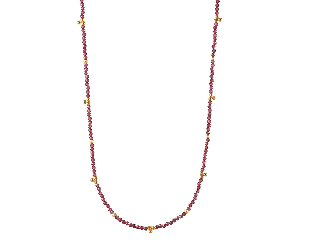 Gold-filled necklace with round garnet stations.