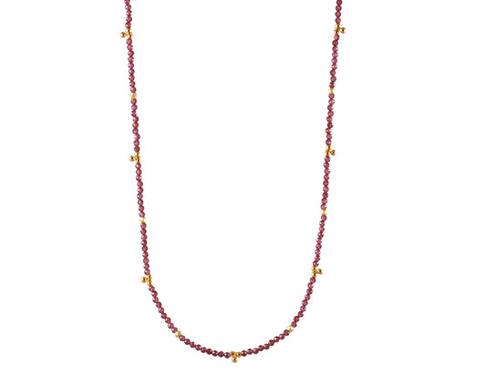 Gold-filled necklace with round garnet stations.
