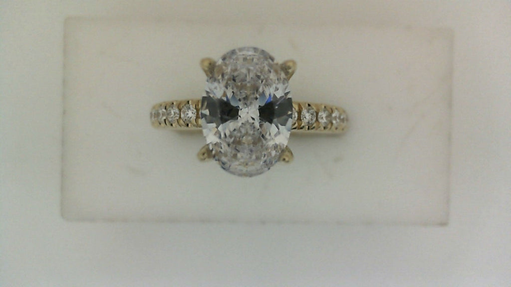 Oval diamond yellow gold engagement ring.