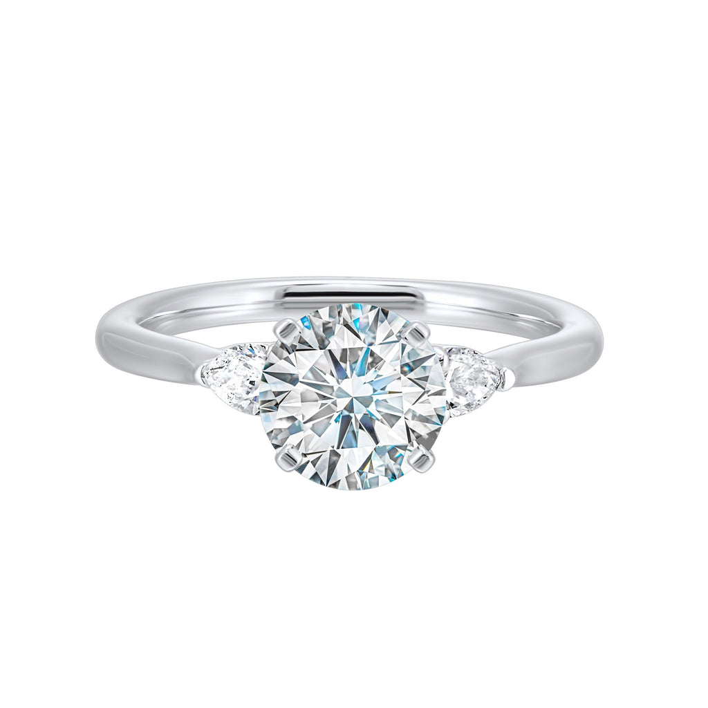 Three-stone diamond ring, white gold, pear accents.
