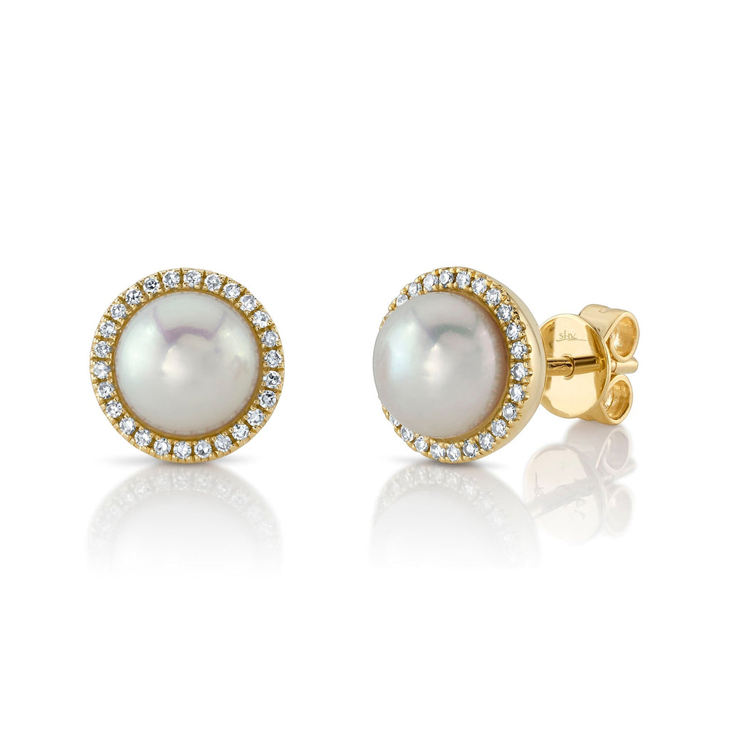 Pearl and diamond halo gold earrings.