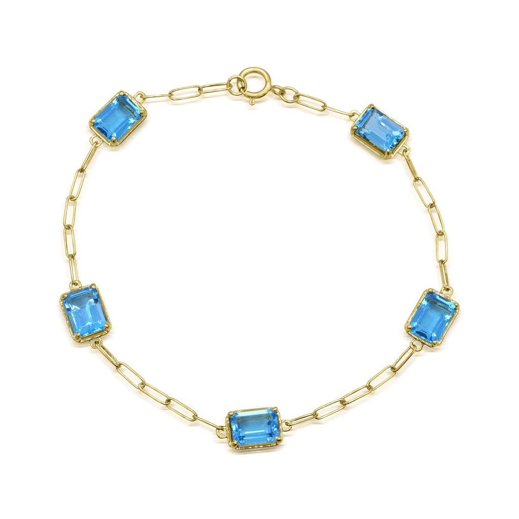 Yellow gold bracelet with emerald-cut blue topazes.