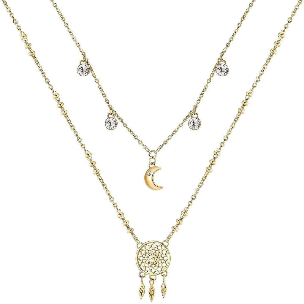 Gold layered necklace with moon and dreamcatcher.