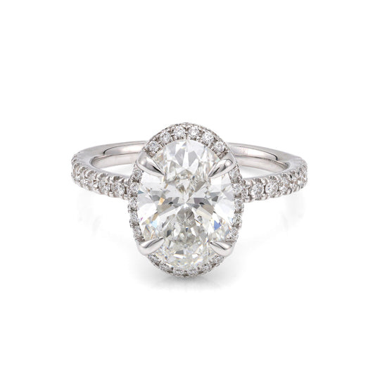 Oval halo diamond engagement ring in white gold.