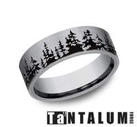 Tantalum grey band with carved tree design.