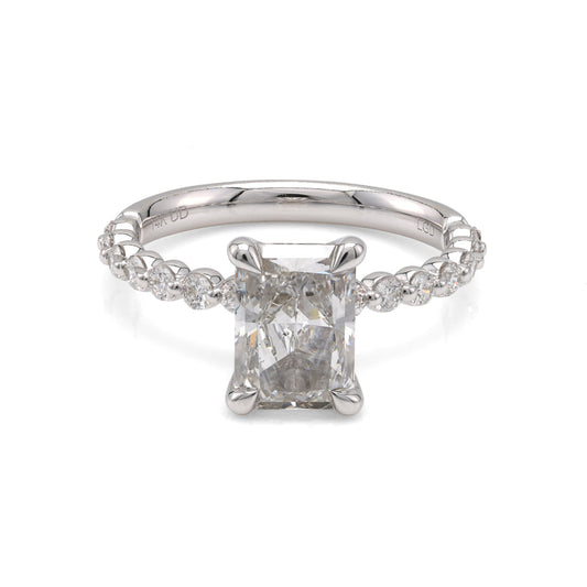 Radiant diamond ring with side stones.