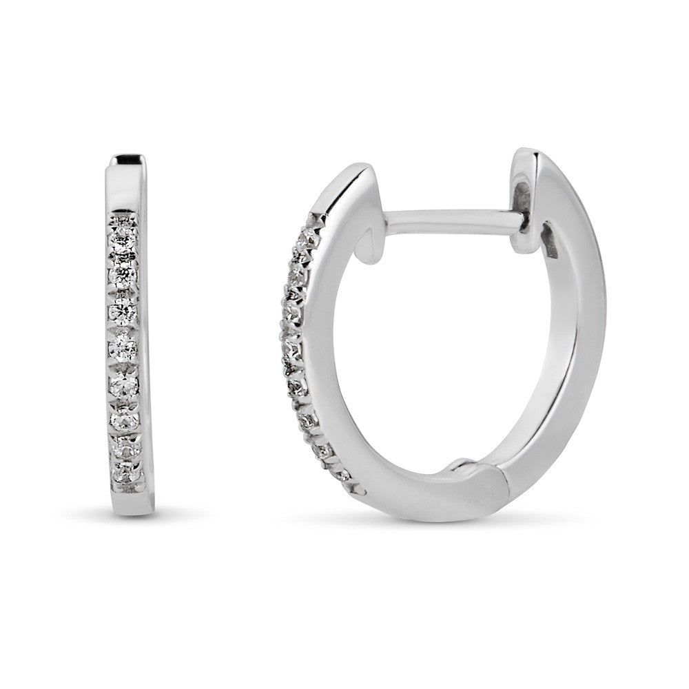 Small white gold hoop earrings with diamonds.