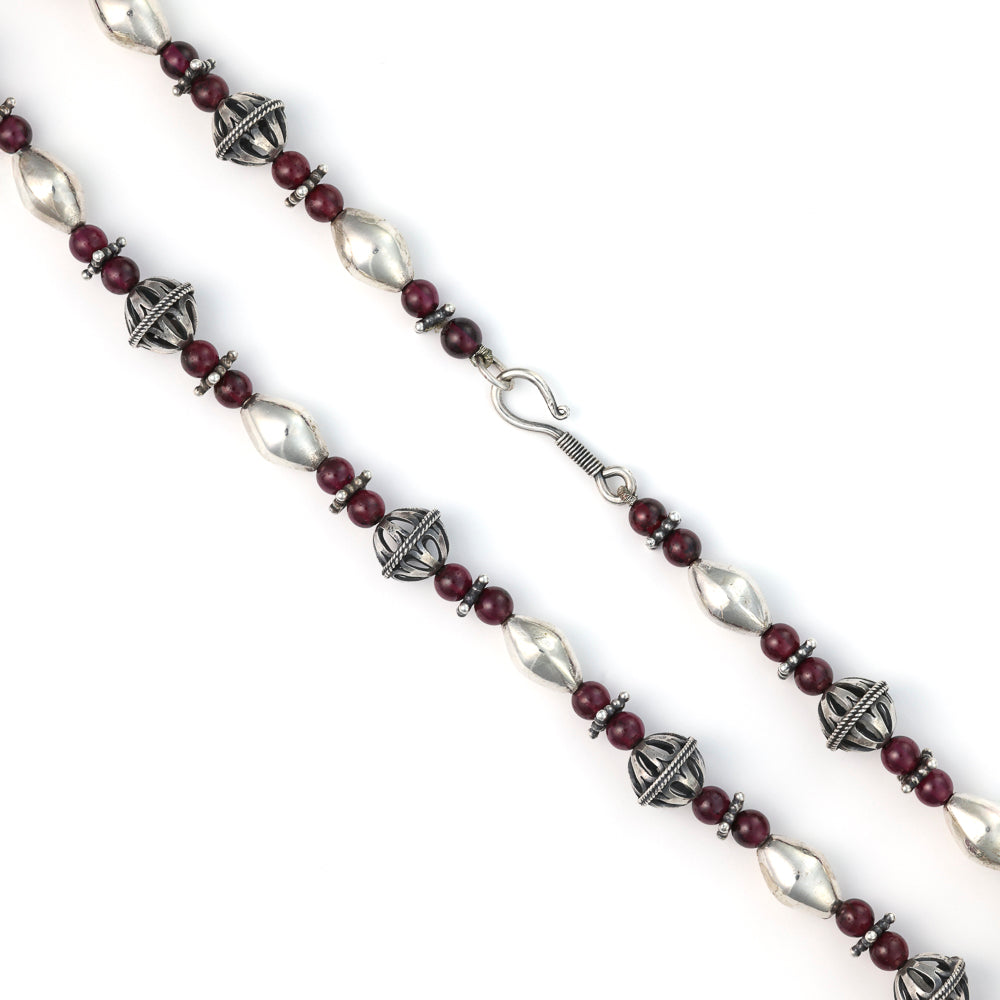 Sterling silver necklace with round garnets.