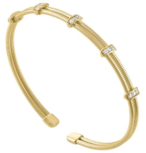 Flexible yellow gold bangle with diamonds.