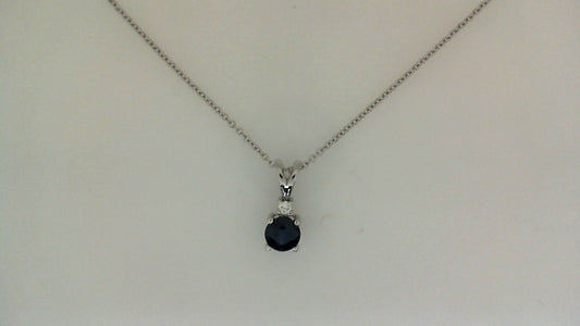 Round sapphire pendant on cable chain.