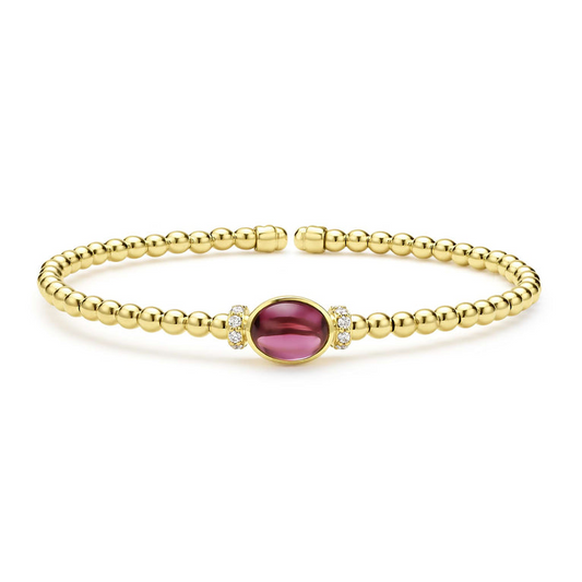 Gold cuff bracelet with rhodolite garnet.