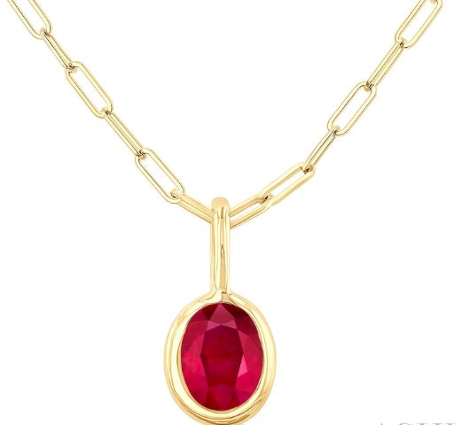 Oval ruby pendant on gold paperclip chain.