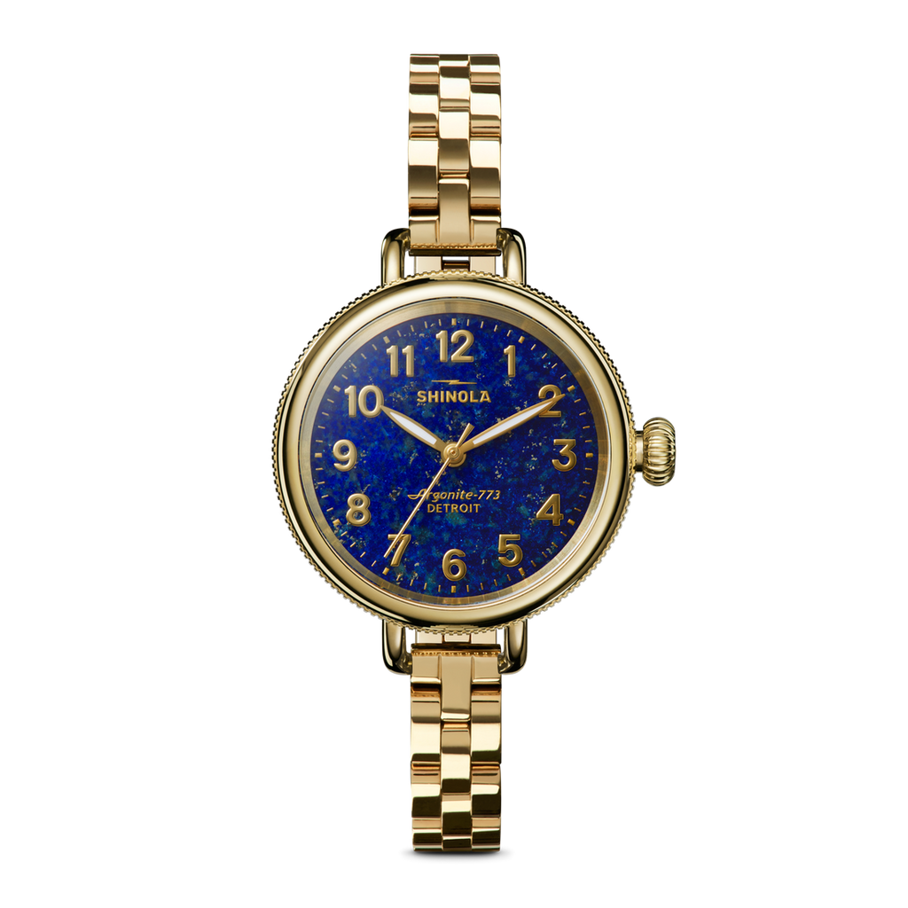 Gold watch with blue dial, stainless steel band.