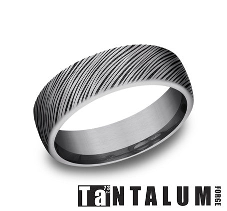 Dark grey tantalum band with carved pattern.