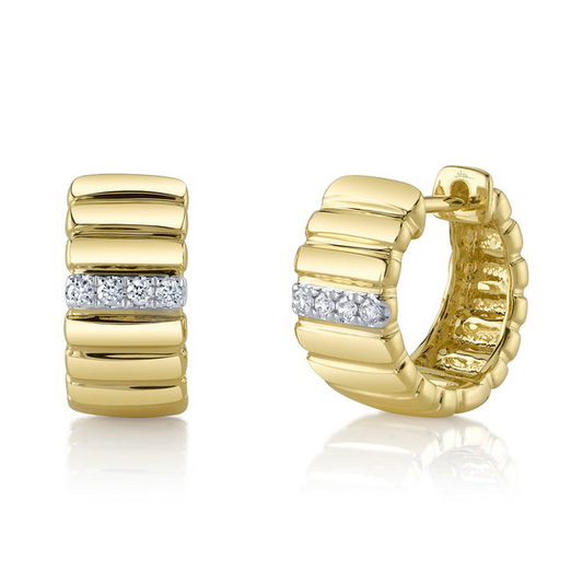 Gold huggie earrings with round diamond accents.