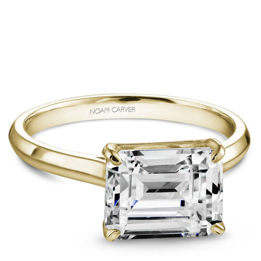 Yellow gold ring with emerald-cut diamond setting.
