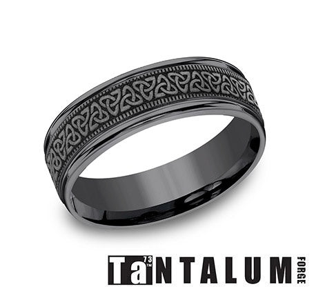 Tantalum grey carved band with textured design.