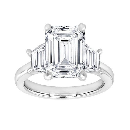 Three-stone emerald diamond ring in white gold.