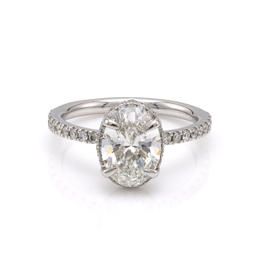 Oval diamond halo engagement ring in white gold.