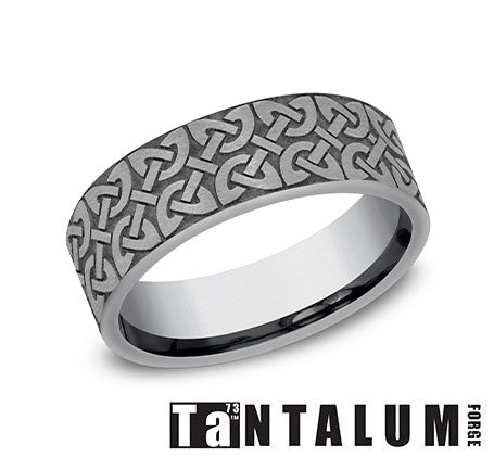Tantalum grey carved band with textured design.