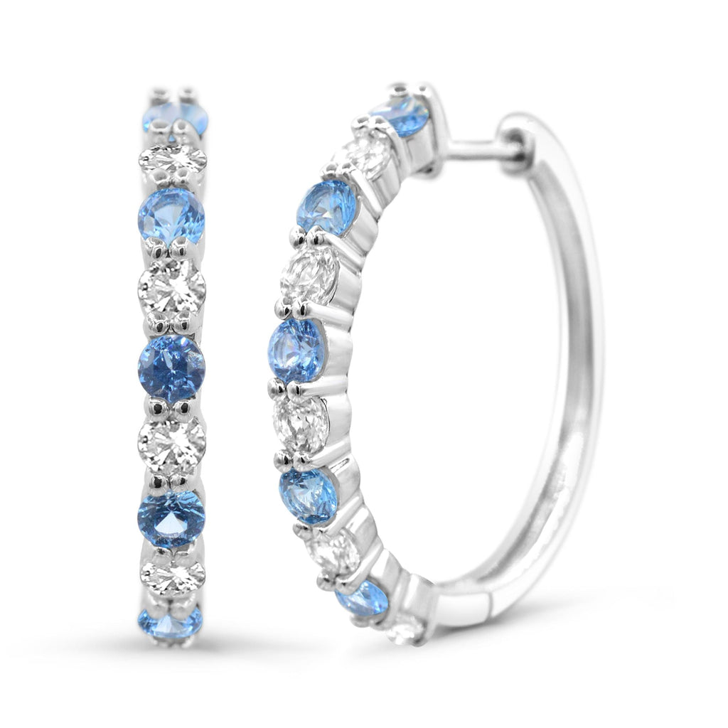Sterling silver hoops with blue topaz gemstones.