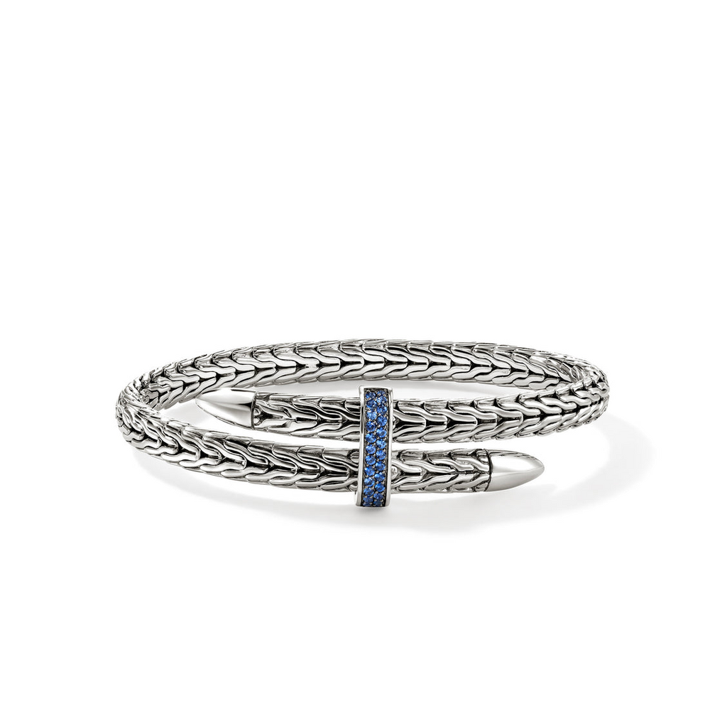 Sterling silver bangle with blue sapphire accents.