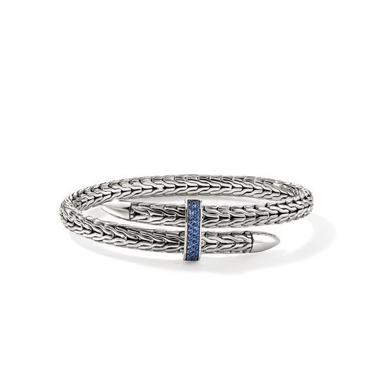 Sterling silver bangle with blue sapphire accents.