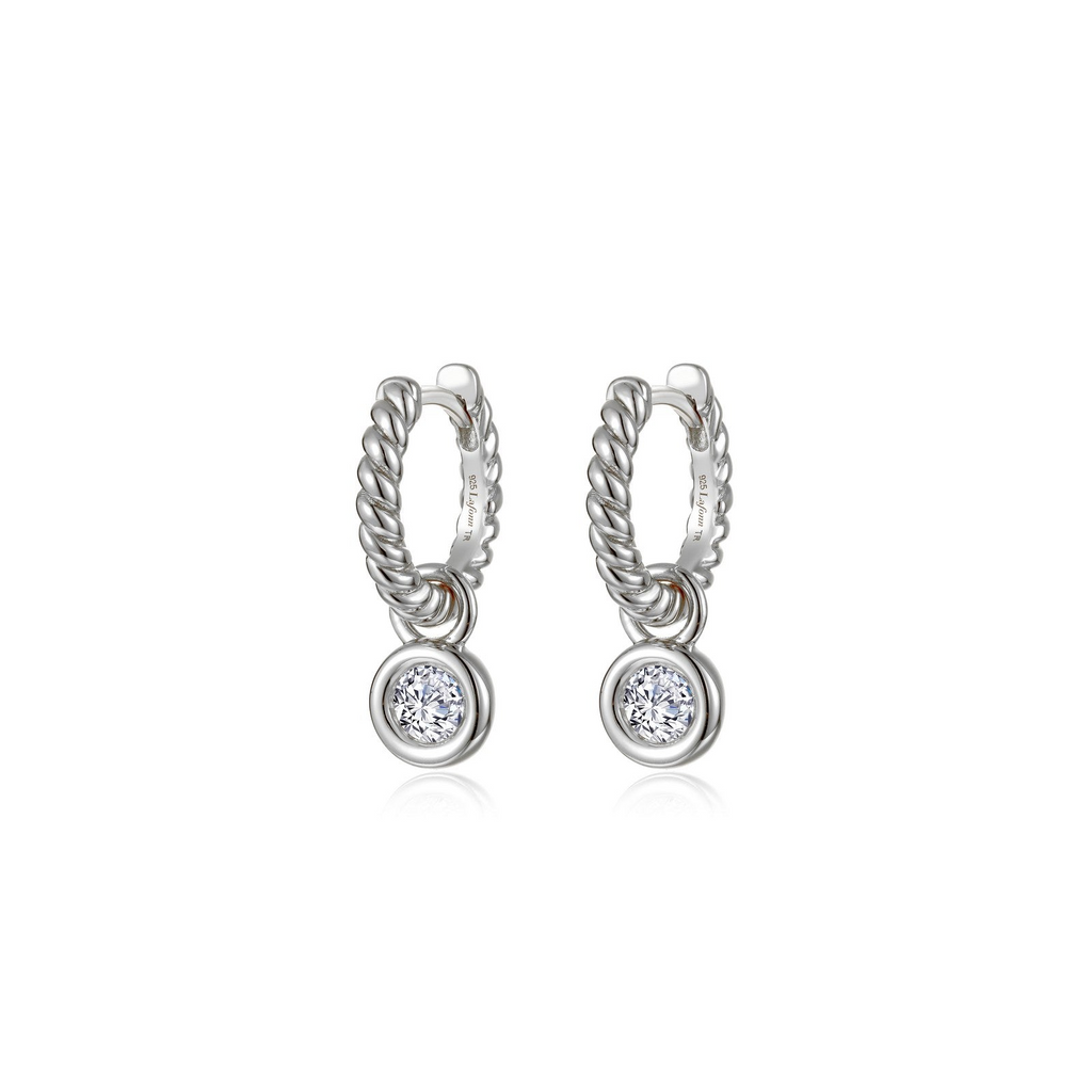 Platinum huggie earrings with round diamonds.