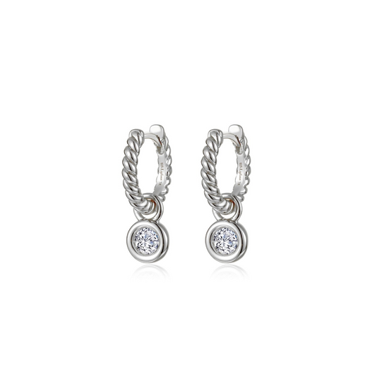 Platinum huggie earrings with round diamonds.