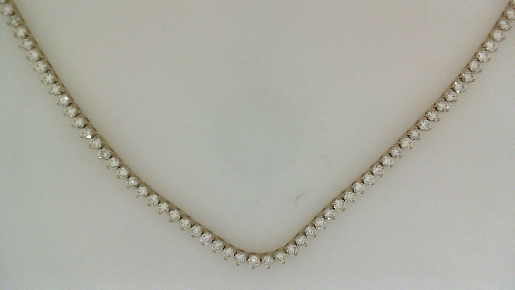 Round diamond tennis necklace in yellow gold.