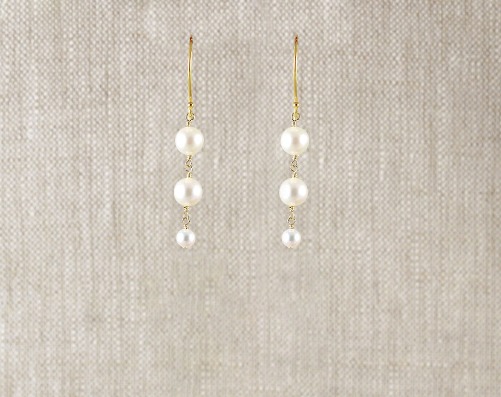 Gold-filled earrings with three round pearls.