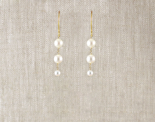 Gold-filled earrings with three round pearls.