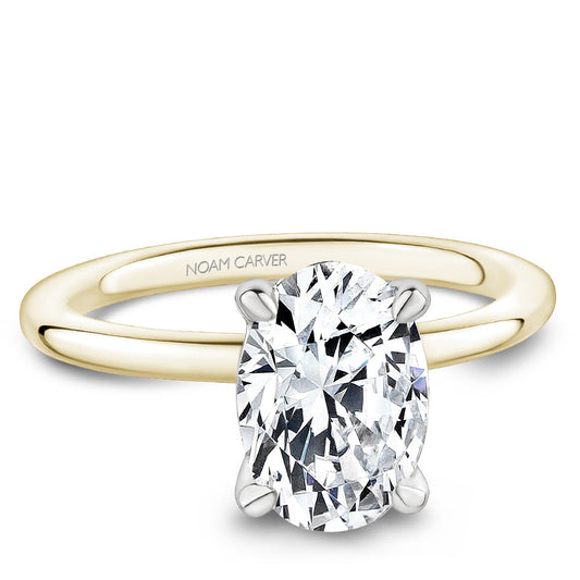 Yellow gold ring with oval diamond setting.