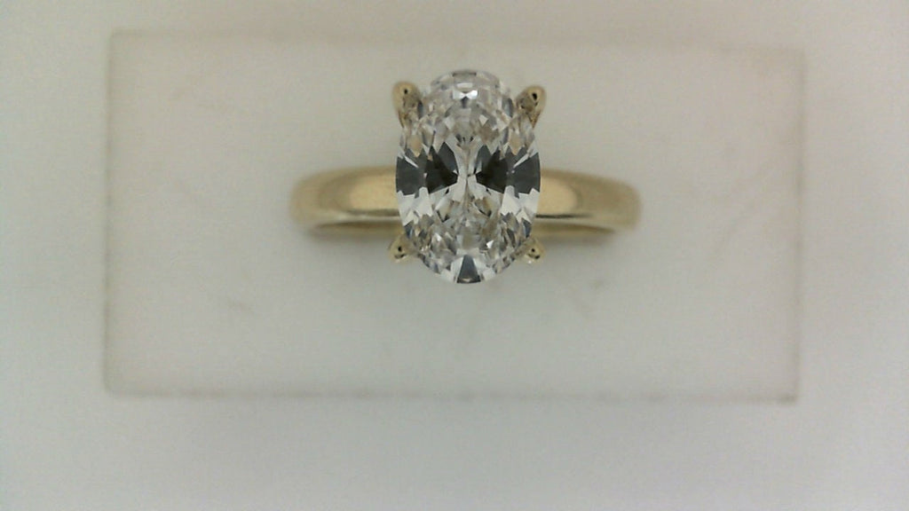 Oval diamond ring in yellow gold setting.