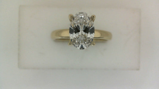 Oval diamond ring in yellow gold setting.