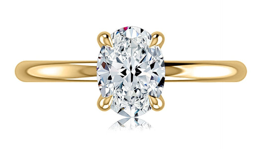 Yellow gold ring with oval diamond centerpiece.