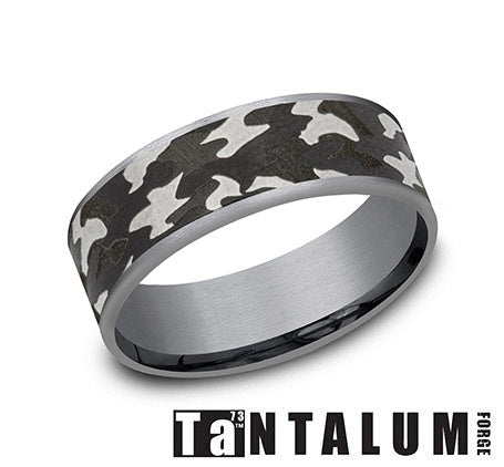 Tantalum band with white-grey carved design.