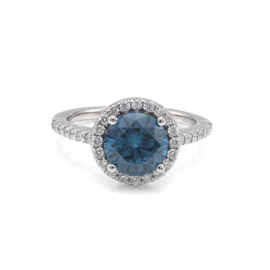 Blue diamond halo engagement ring in white gold.