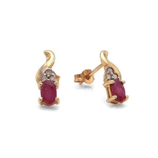Oval ruby earrings with diamond accents, yellow gold.