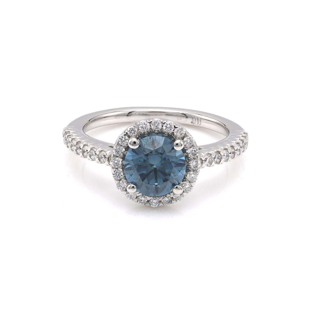 Blue diamond halo engagement ring in white gold.