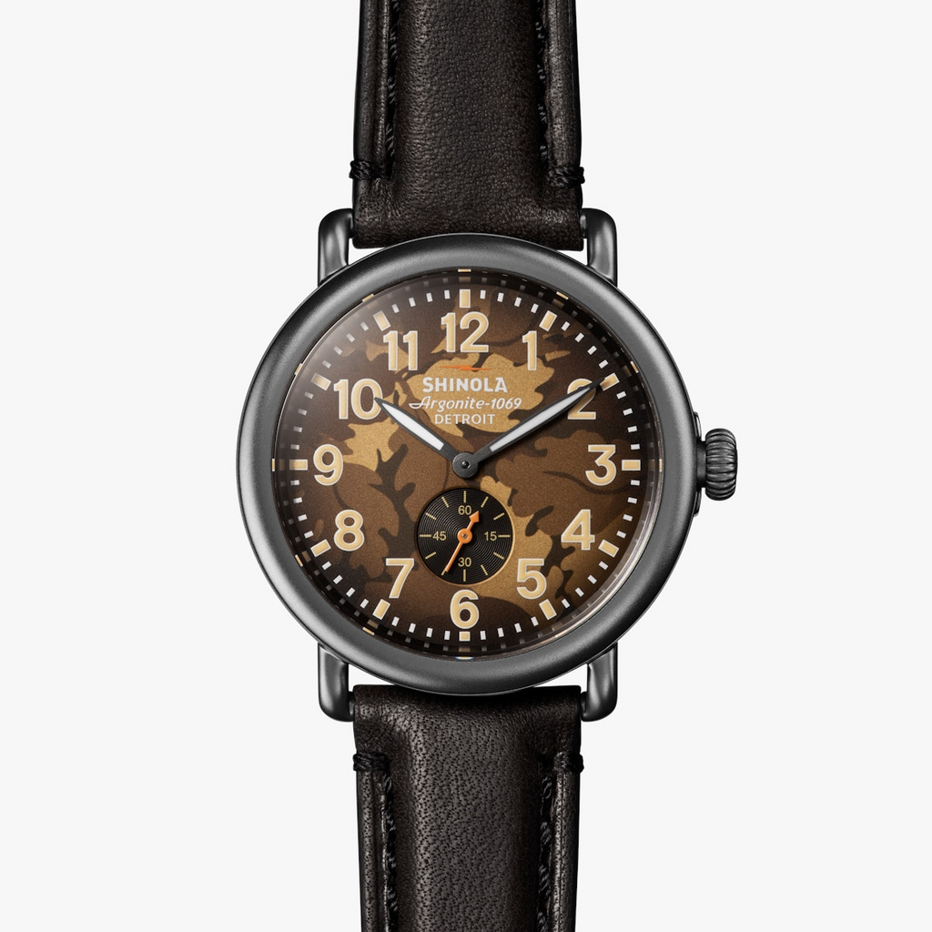 Olive camo dial, stainless steel case, leather band.