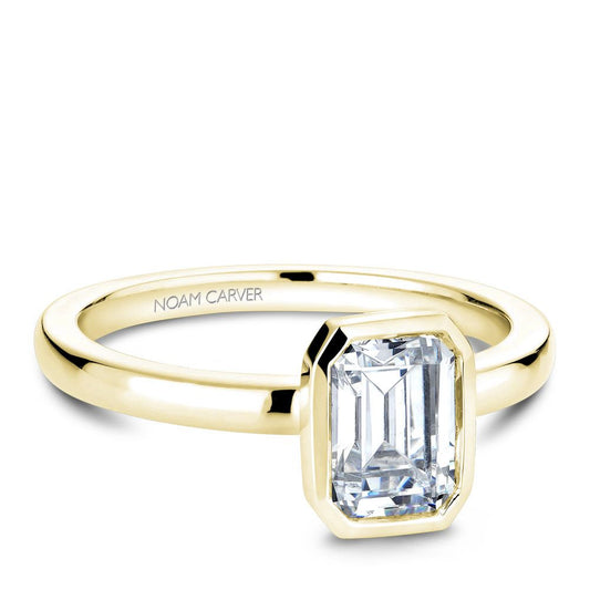 Yellow gold ring with emerald-cut diamond.