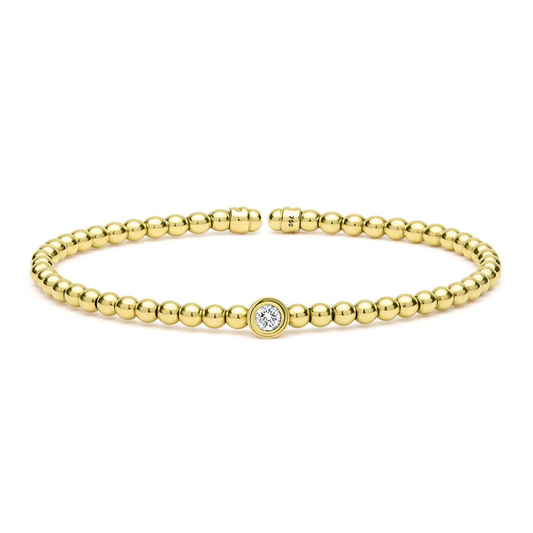Gold beaded cuff bracelet with diamond.