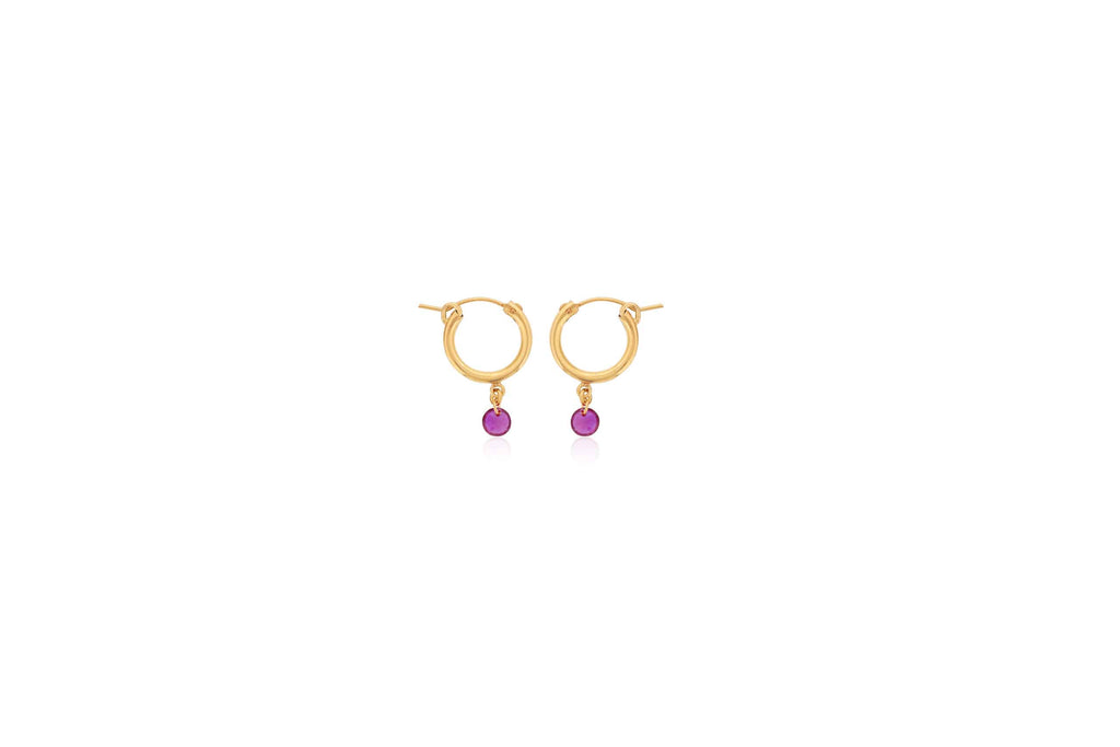 Gold hoop earrings with dangling rubies.