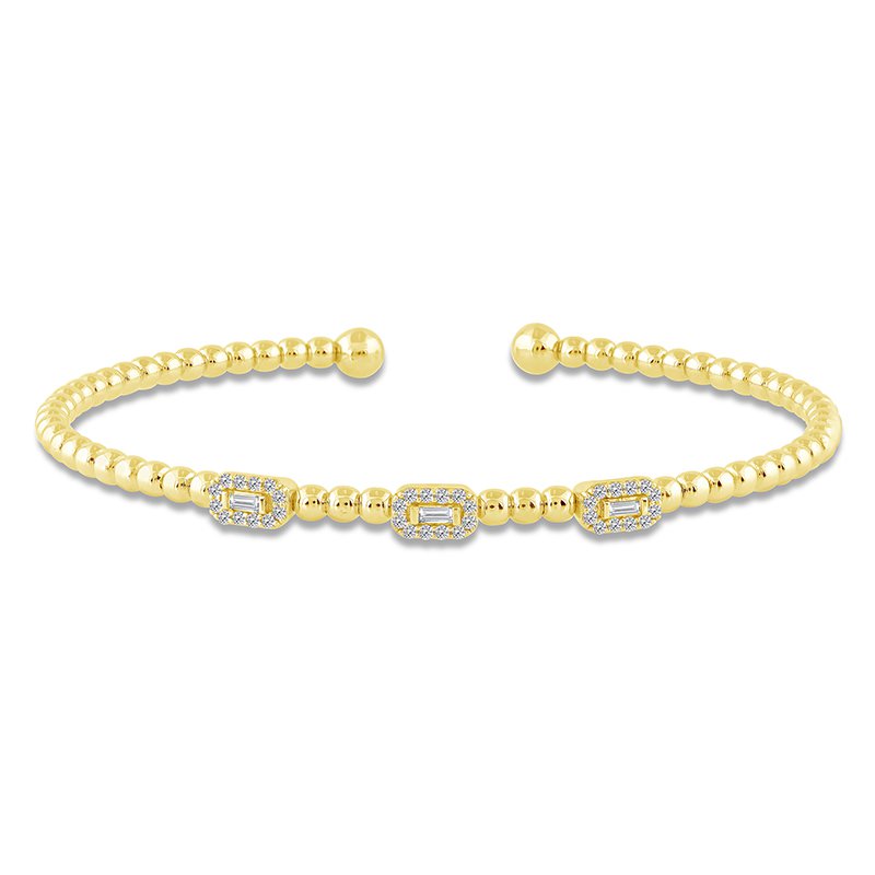 Yellow gold bangle with diamond accents.