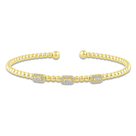 Yellow gold bangle with diamond shapes.