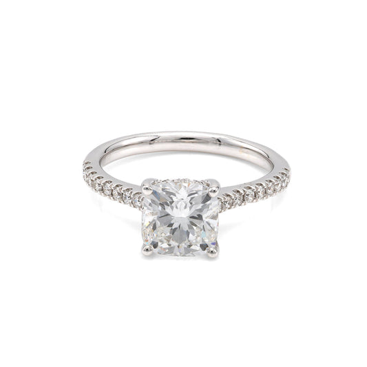 Cushion-cut diamond ring with diamond accents.