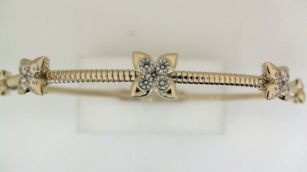Yellow gold bracelet with diamond floral accents.